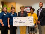 Sharonview delivers check to Cleveland County Schools