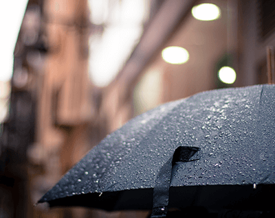 Umbrella with rain drops rolling off