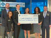 Sharonview delivers check to Charlotte Family Housing